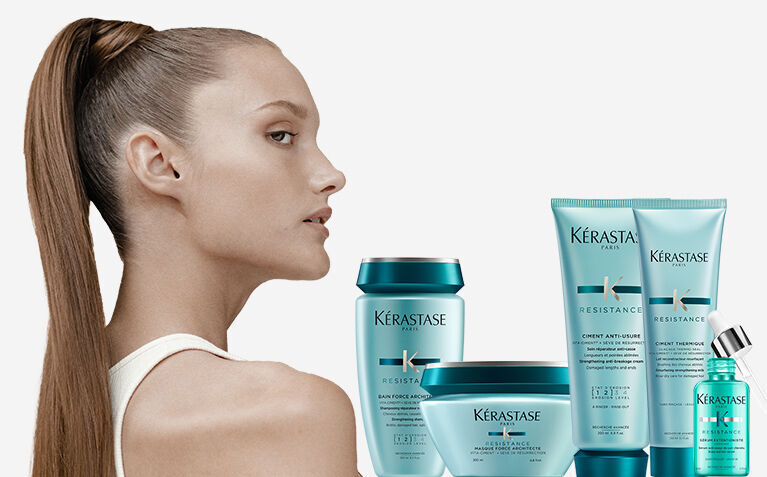 Kerastase Resistance model with hair care products for damaged hair