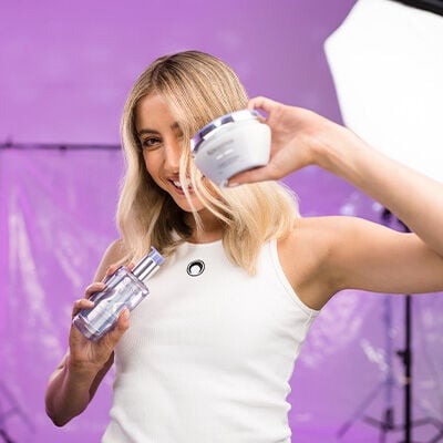 Rebecca Harding holding Kerastase Blond Absolu products